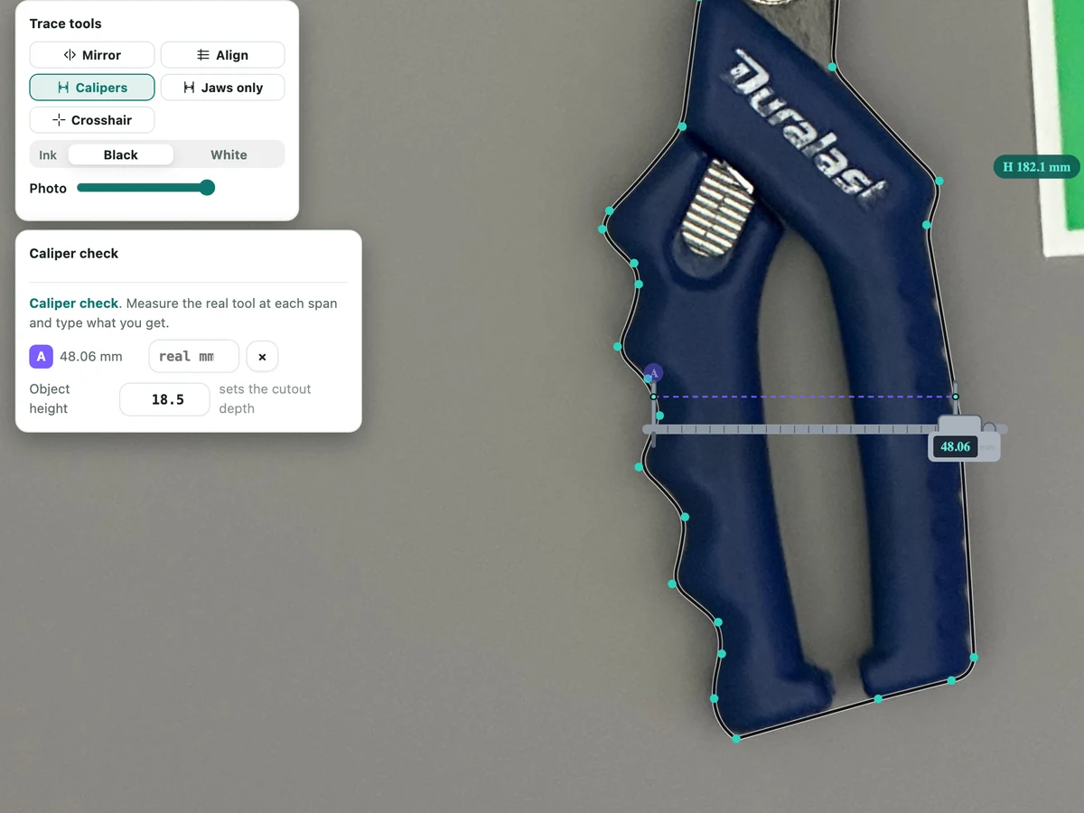Gridbox Pro's Caliper check up close: calipers clamped across the snips handle read 48.06 mm, pinned as A, with a box to type what your real calipers read