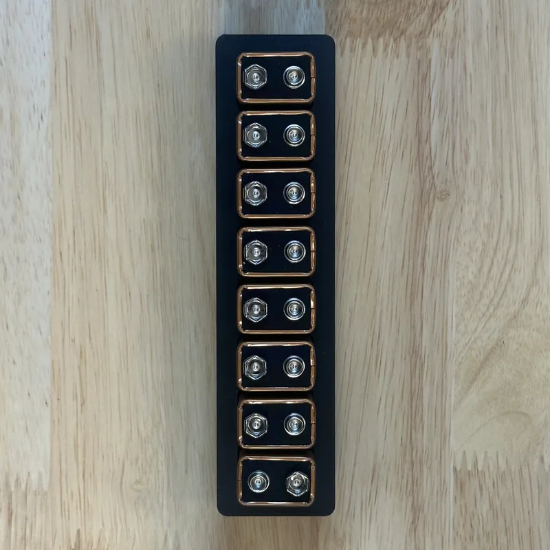 A narrow bin holding a row of 9-volt batteries